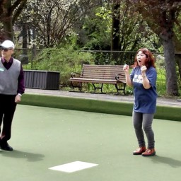 The staff member is delighted with a shot during opening day at Willowdale Lawn Bowling Club. 