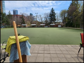 View of the artificial bowling surface with cleaning utensils in the foreground. 